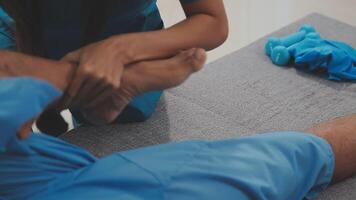 Patient at the physiotherapy doing physical exercises with his therapist video