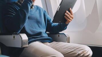 Side view portrait of handsome bearded businessman working while enjoying flight in first class, copy space video