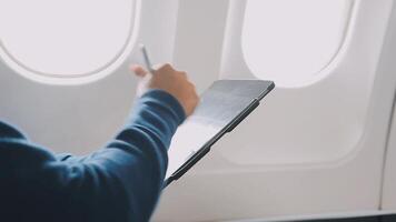 Side view portrait of handsome bearded businessman working while enjoying flight in first class, copy space video