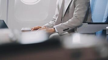 Side view portrait of handsome bearded businessman working while enjoying flight in first class, copy space video