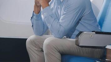 Side view portrait of handsome bearded businessman working while enjoying flight in first class, copy space video