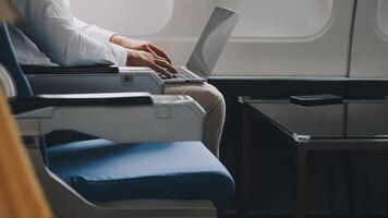 Side view portrait of handsome bearded businessman working while enjoying flight in first class, copy space video