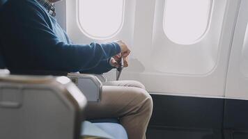 Side view portrait of handsome bearded businessman working while enjoying flight in first class, copy space video