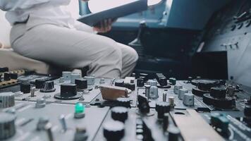 The pilot presses the power buttons on the control panel to control the aircraft in front of cockpit windshield video