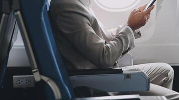 Side view portrait of handsome bearded businessman working while enjoying flight in first class, copy space video