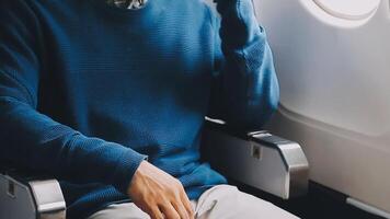 Side view portrait of handsome bearded businessman working while enjoying flight in first class, copy space video