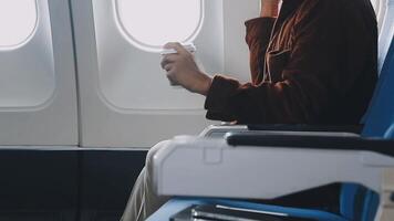 Side view portrait of handsome bearded businessman working while enjoying flight in first class, copy space video