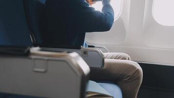 Side view portrait of handsome bearded businessman working while enjoying flight in first class, copy space video