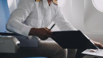 Side view portrait of handsome bearded businessman working while enjoying flight in first class, copy space video