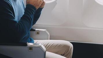 Side view portrait of handsome bearded businessman working while enjoying flight in first class, copy space video