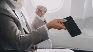 Side view portrait of handsome bearded businessman working while enjoying flight in first class, copy space video