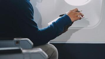 Side view portrait of handsome bearded businessman working while enjoying flight in first class, copy space video