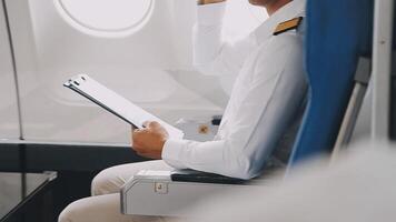 Side view portrait of handsome bearded businessman working while enjoying flight in first class, copy space video