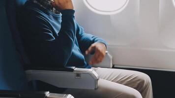 Side view portrait of handsome bearded businessman working while enjoying flight in first class, copy space video