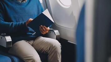 Side view portrait of handsome bearded businessman working while enjoying flight in first class, copy space video