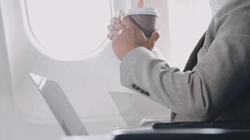 Side view portrait of handsome bearded businessman working while enjoying flight in first class, copy space video