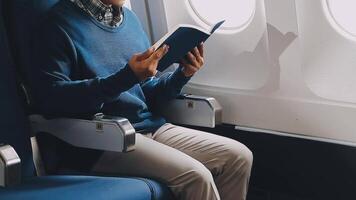 Side view portrait of handsome bearded businessman working while enjoying flight in first class, copy space video