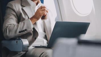 Side view portrait of handsome bearded businessman working while enjoying flight in first class, copy space video