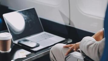 Side view portrait of handsome bearded businessman working while enjoying flight in first class, copy space video