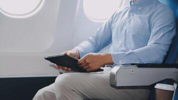 Side view portrait of handsome bearded businessman working while enjoying flight in first class, copy space video