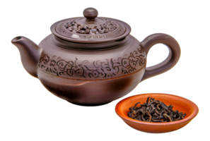 A tea pot with a lid sits on a table next to a small bowl of tea - stock .. png