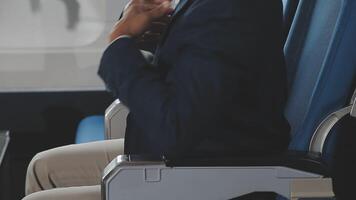 Side view portrait of handsome bearded businessman working while enjoying flight in first class, copy space video