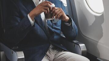 Side view portrait of handsome bearded businessman working while enjoying flight in first class, copy space video