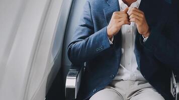 Side view portrait of handsome bearded businessman working while enjoying flight in first class, copy space video