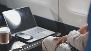 Side view portrait of handsome bearded businessman working while enjoying flight in first class, copy space video