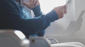 Side view portrait of handsome bearded businessman working while enjoying flight in first class, copy space video