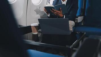 Side view portrait of handsome bearded businessman working while enjoying flight in first class, copy space video