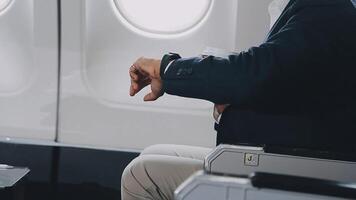 Side view portrait of handsome bearded businessman working while enjoying flight in first class, copy space video