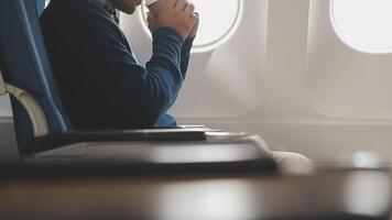 Side view portrait of handsome bearded businessman working while enjoying flight in first class, copy space video