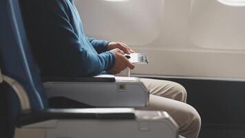 Side view portrait of handsome bearded businessman working while enjoying flight in first class, copy space video