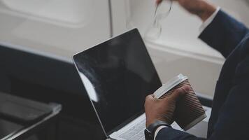 Side view portrait of handsome bearded businessman working while enjoying flight in first class, copy space video