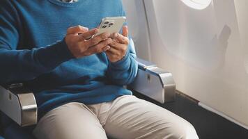 Side view portrait of handsome bearded businessman working while enjoying flight in first class, copy space video