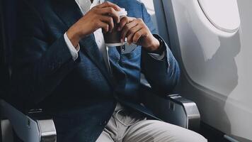 Side view portrait of handsome bearded businessman working while enjoying flight in first class, copy space video