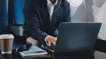 Side view portrait of handsome bearded businessman working while enjoying flight in first class, copy space video