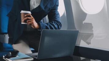 Side view portrait of handsome bearded businessman working while enjoying flight in first class, copy space video