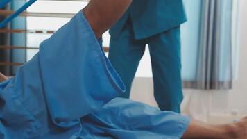 Patient at the physiotherapy doing physical exercises with his therapist video