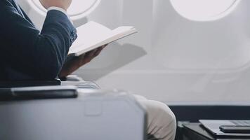 Side view portrait of handsome bearded businessman working while enjoying flight in first class, copy space video
