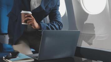 Side view portrait of handsome bearded businessman working while enjoying flight in first class, copy space video