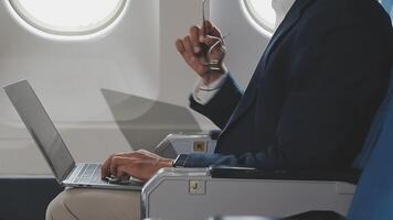 Side view portrait of handsome bearded businessman working while enjoying flight in first class, copy space video