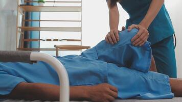 Patient at the physiotherapy doing physical exercises with his therapist video