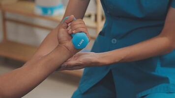 Doctor or Physiotherapist working examining treating injured arm of athlete male patient, stretching and exercise, Doing the Rehabilitation therapy pain in clinic. video