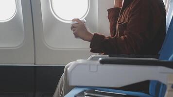 Side view portrait of handsome bearded businessman working while enjoying flight in first class, copy space video