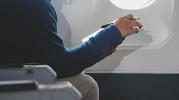Side view portrait of handsome bearded businessman working while enjoying flight in first class, copy space video