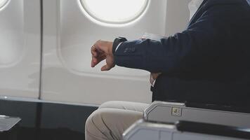 Side view portrait of handsome bearded businessman working while enjoying flight in first class, copy space video