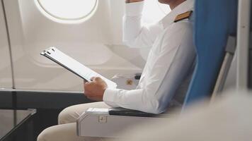 Side view portrait of handsome bearded businessman working while enjoying flight in first class, copy space video