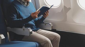 Side view portrait of handsome bearded businessman working while enjoying flight in first class, copy space video